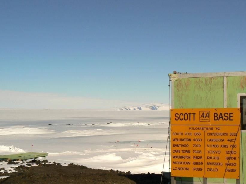 Road sign with distance to your favorite city - note seals on sea ice in the background